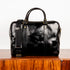 Black leather bag on a wooden surface with a white background